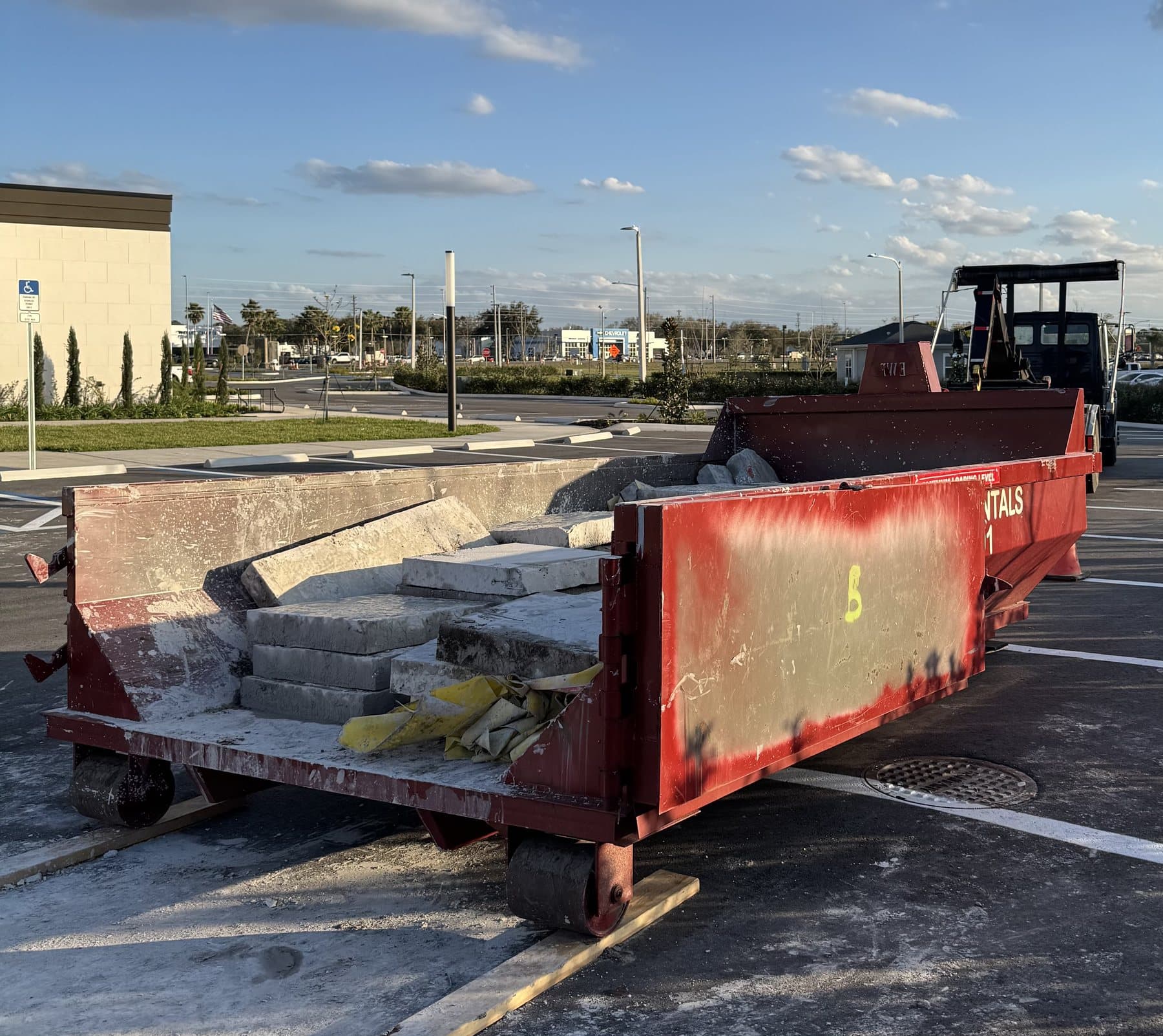 10 yard DumpsterX dumpster loaded with concrete slabs
