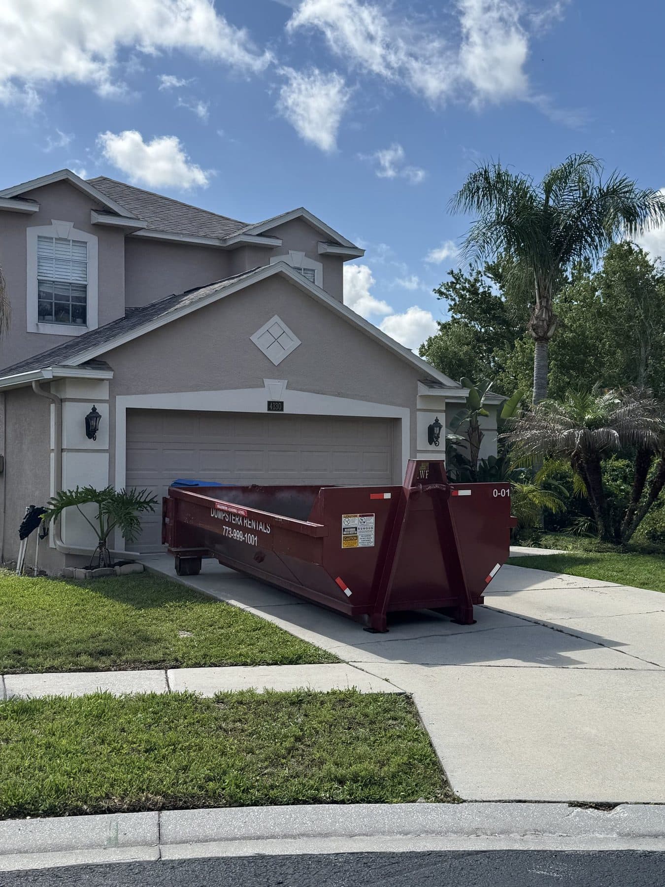 10 yard DumpsterX roll-off dumpster placed at a home