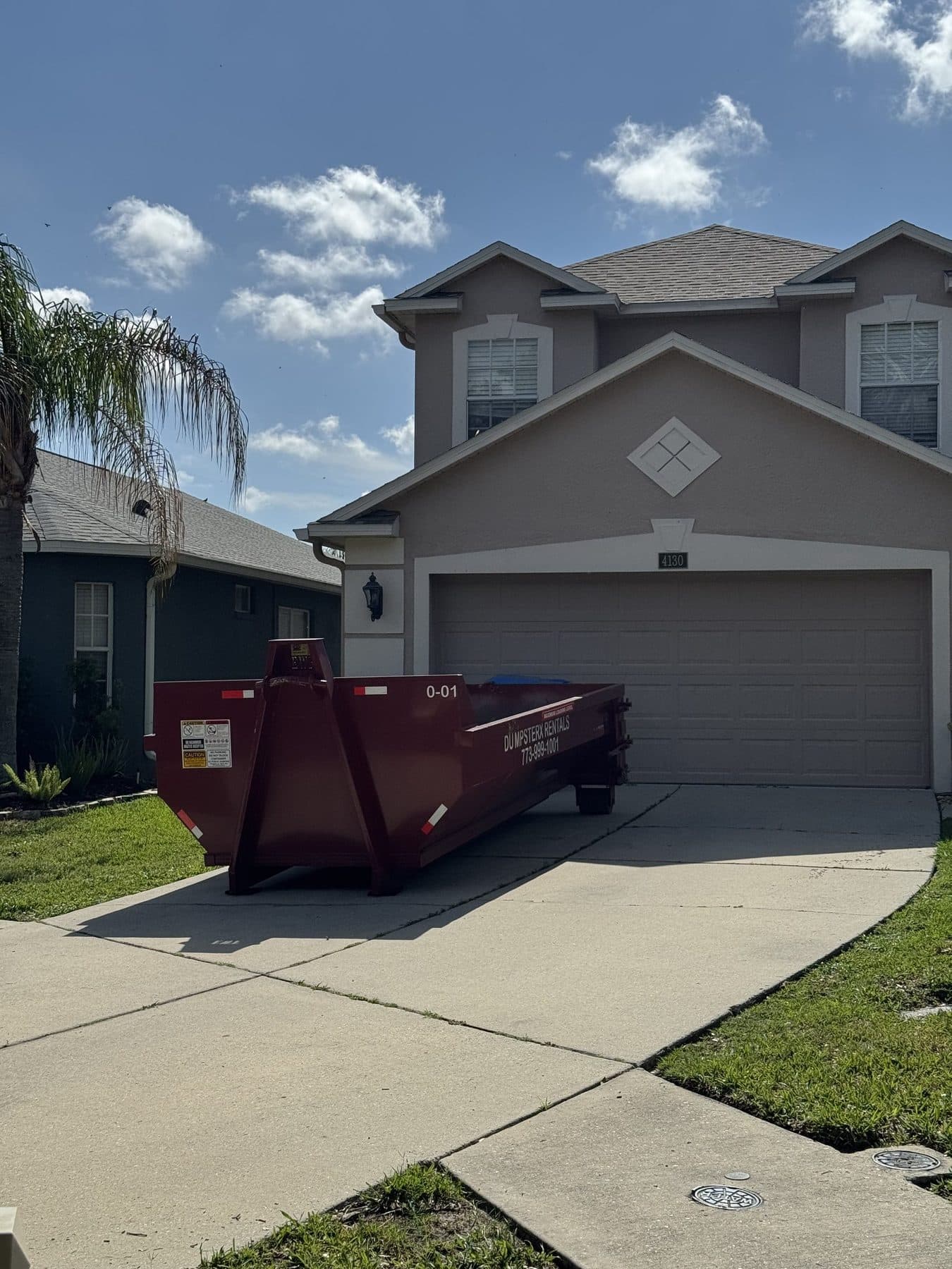 10 yard DumpsterX roll-off dumpster on a residential job