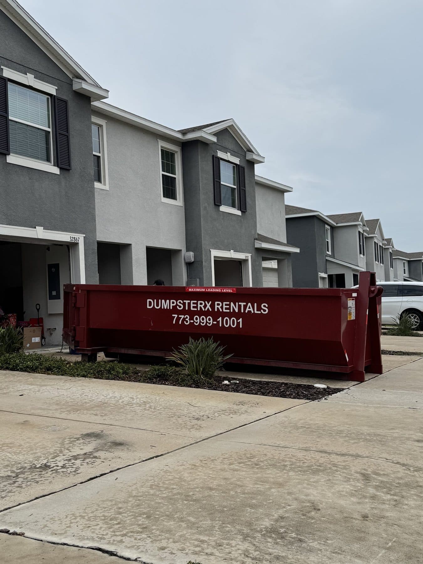 17 yard DumpsterX dumpster outside townhomes during a junk cleanout