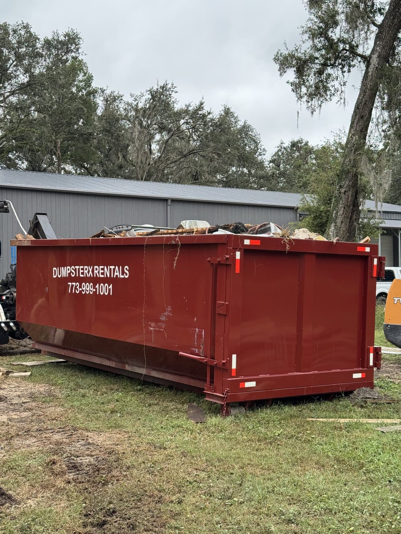 30 yard DumpsterX dumpster loaded with construction debris and household junk