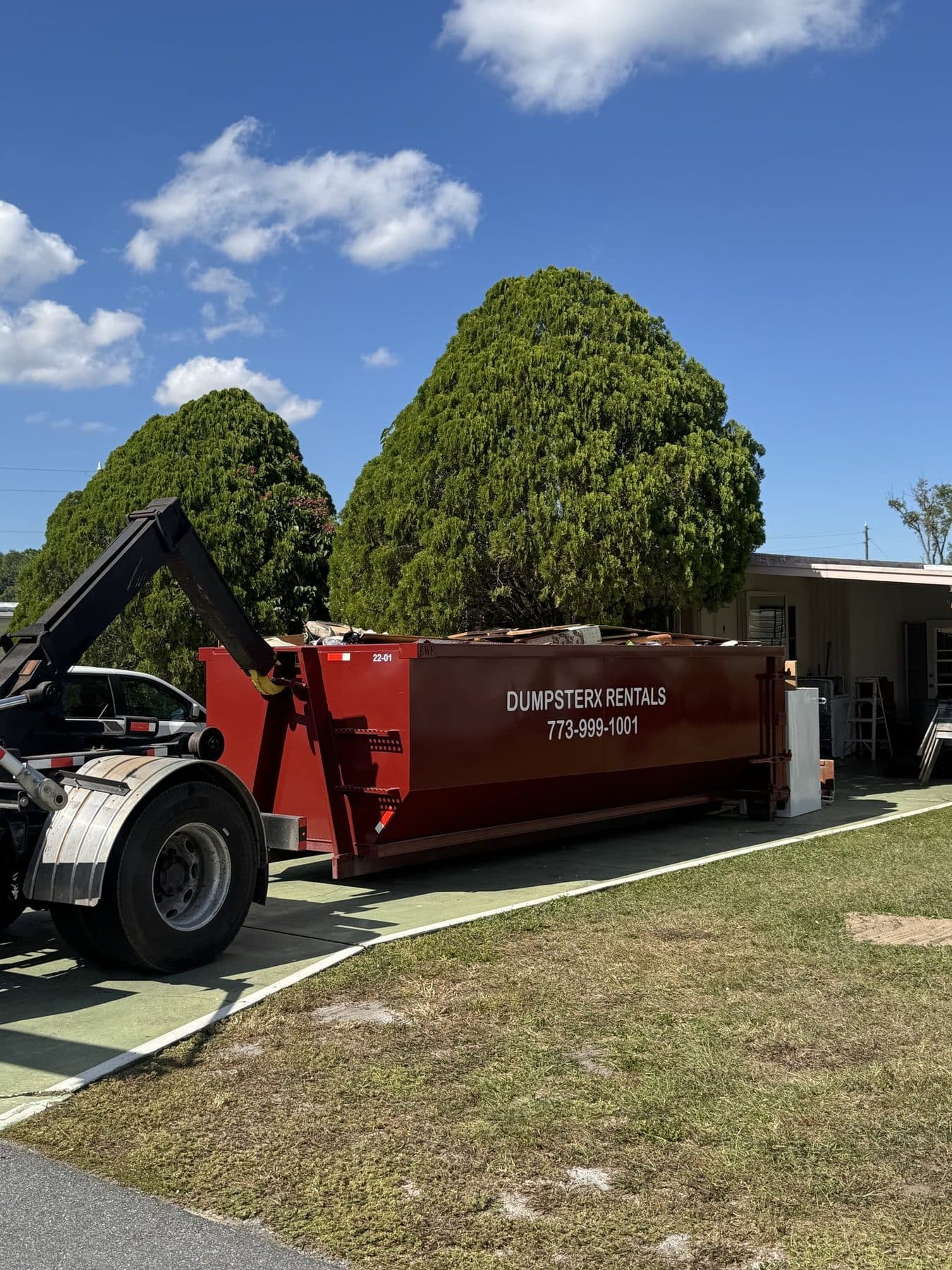 DumpsterX truck making a residential dumpster delivery in Pasco County FL