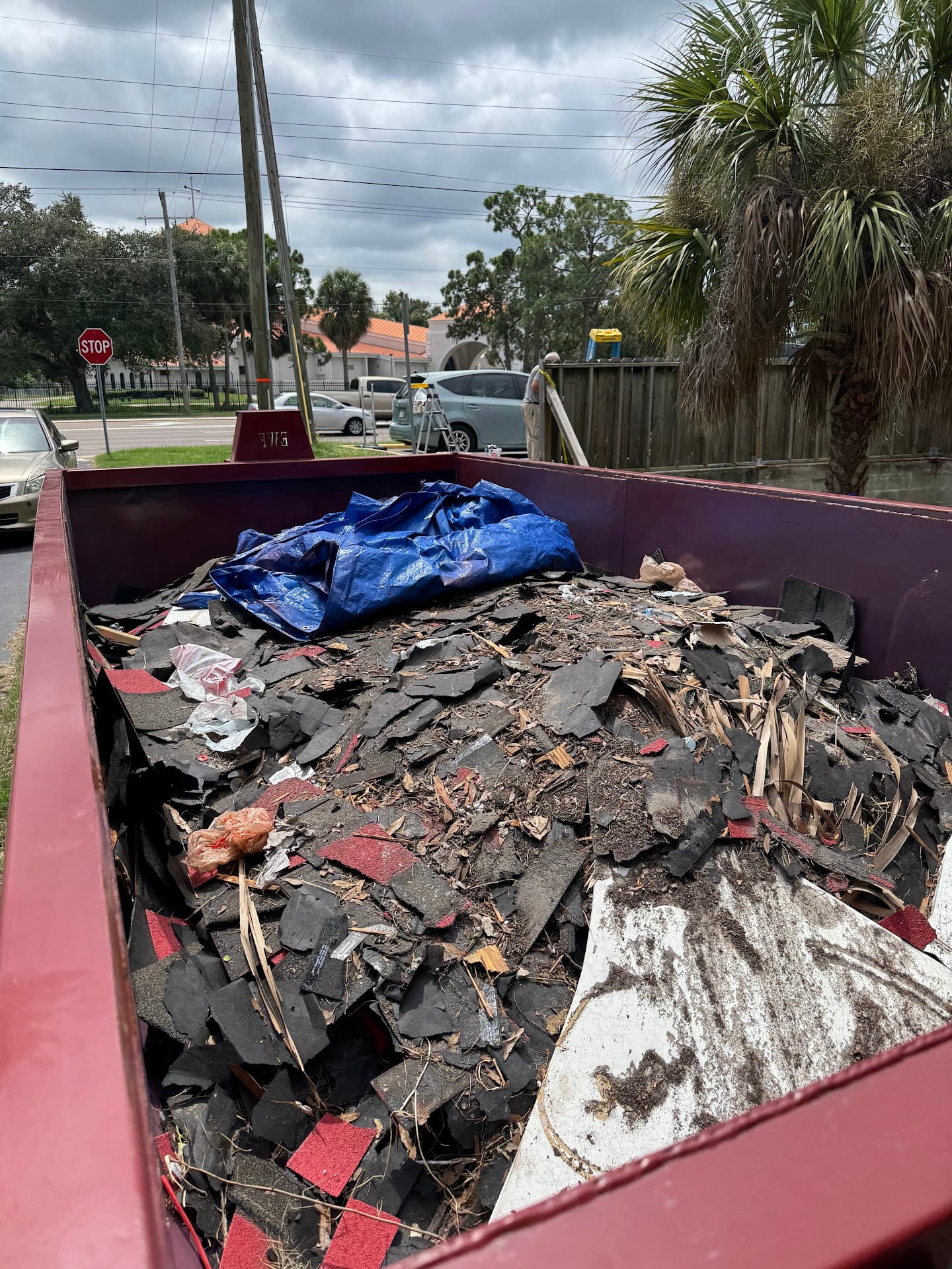 DumpsterX roll-off dumpster loaded with torn-off asphalt roofing shingles