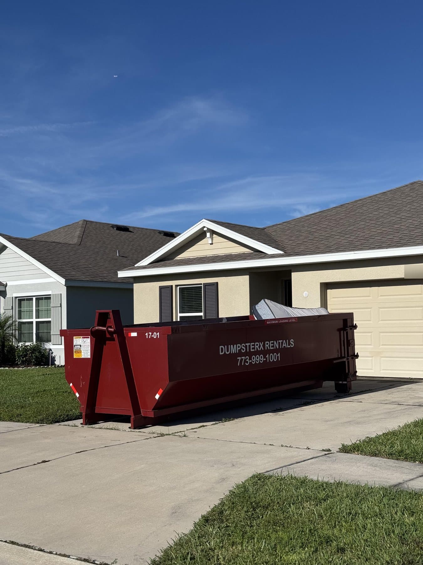 17 yard DumpsterX roll-off dumpster on a driveway